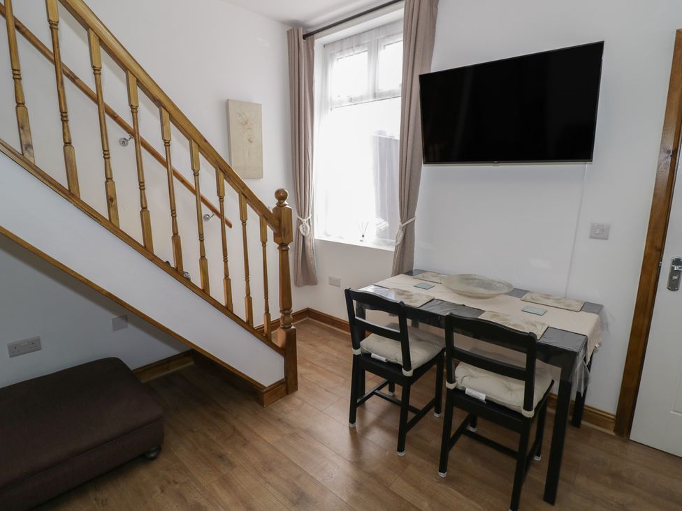 A dining area with a table and chairs at JMG House in West Bromwich