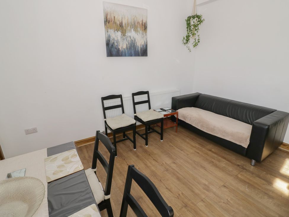 A living room with a sofa and chairs at JMG House in West Bromwich