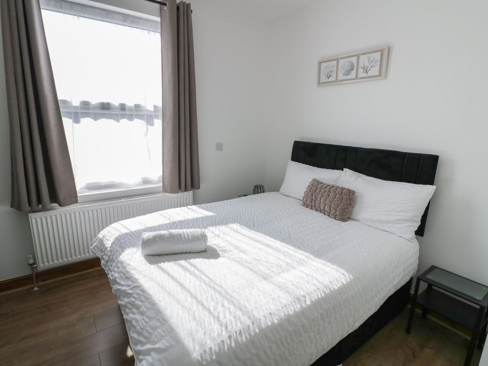 A bedroom with a bed and a window at JMG House West Bromwich