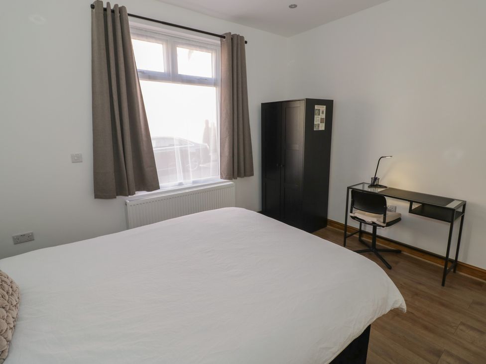 A bedroom with a bed and desk at JMG House West Bromwich