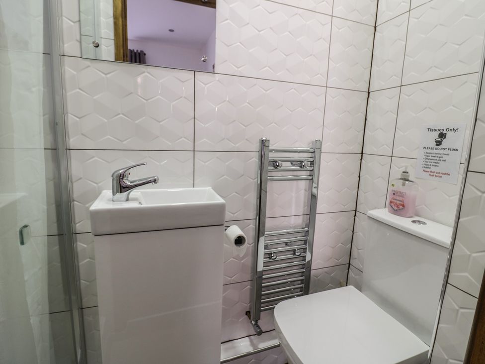 A bathroom featuring a sink and toilet at JMG House in West Bromwich