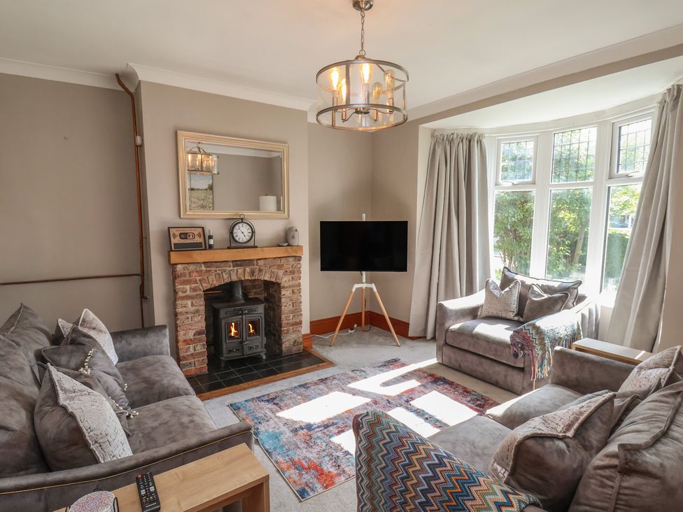 A living room with a fireplace and television at 44 Love Lane, Whitby