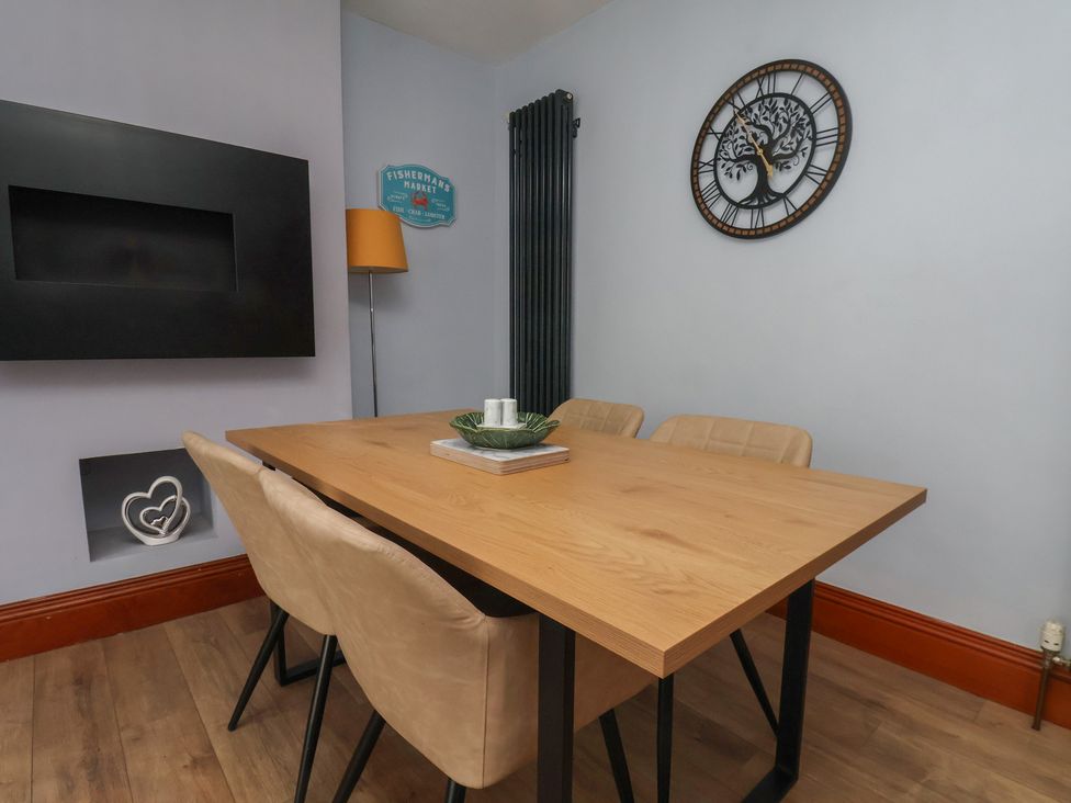 A dining room with a table and chairs at 44 Love Lane in Whitby