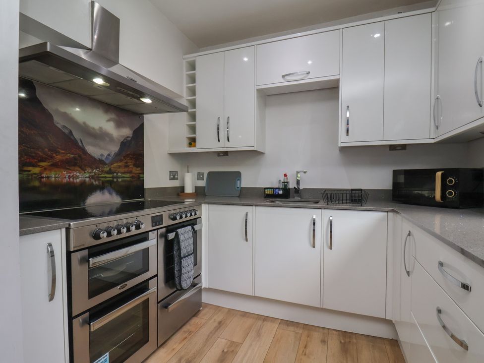 A kitchen with modern appliances and cabinets at 44 Love Lane Whitby