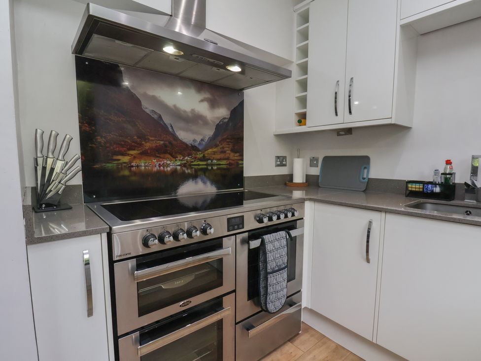 A kitchen with an oven and hob at 44 Love Lane in Whitby