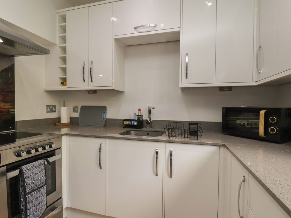 A kitchen with cabinets, sink, oven, and microwave at 44 Love Lane Whitby