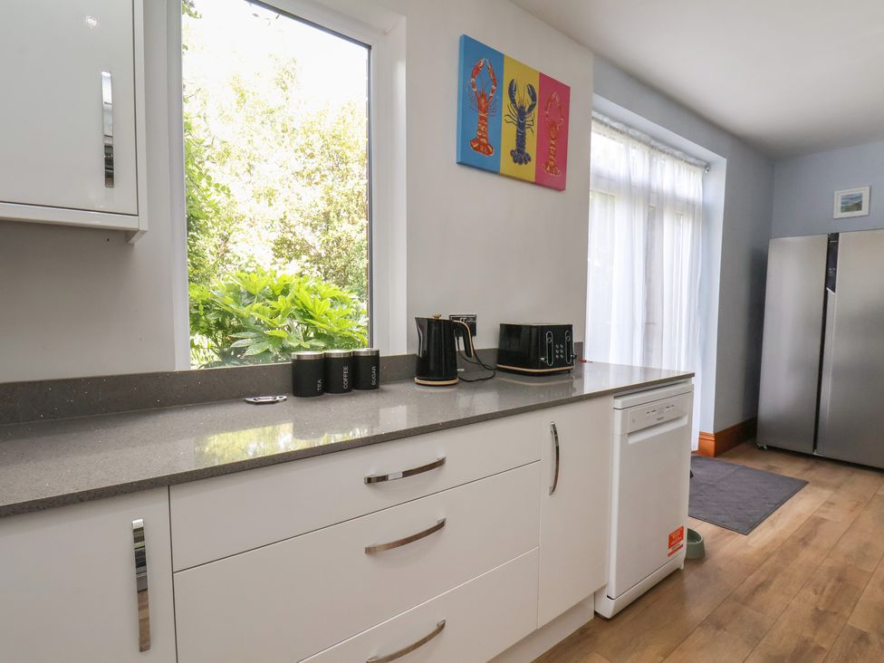 A kitchen with appliances and windows at 44 Love Lane, Whitby