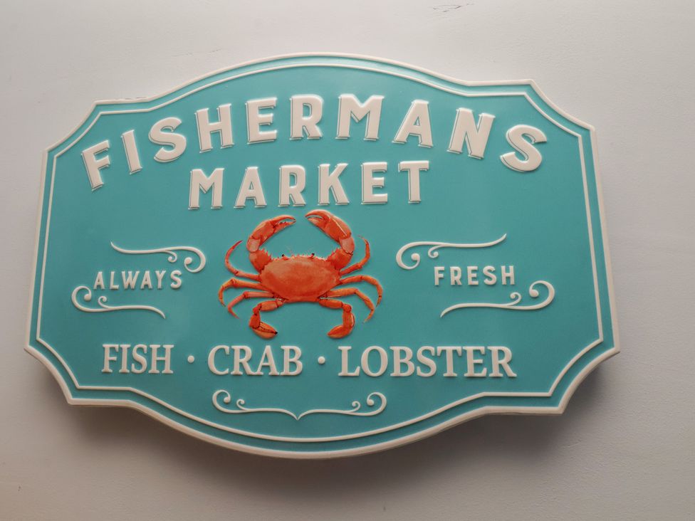 A sign for a fish market featuring a crab at 44 Love Lane, Whitby