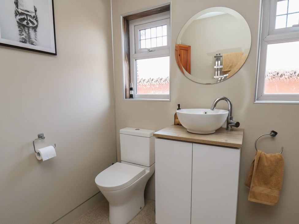 A bathroom with a toilet and sink at 44 Love Lane in Whitby