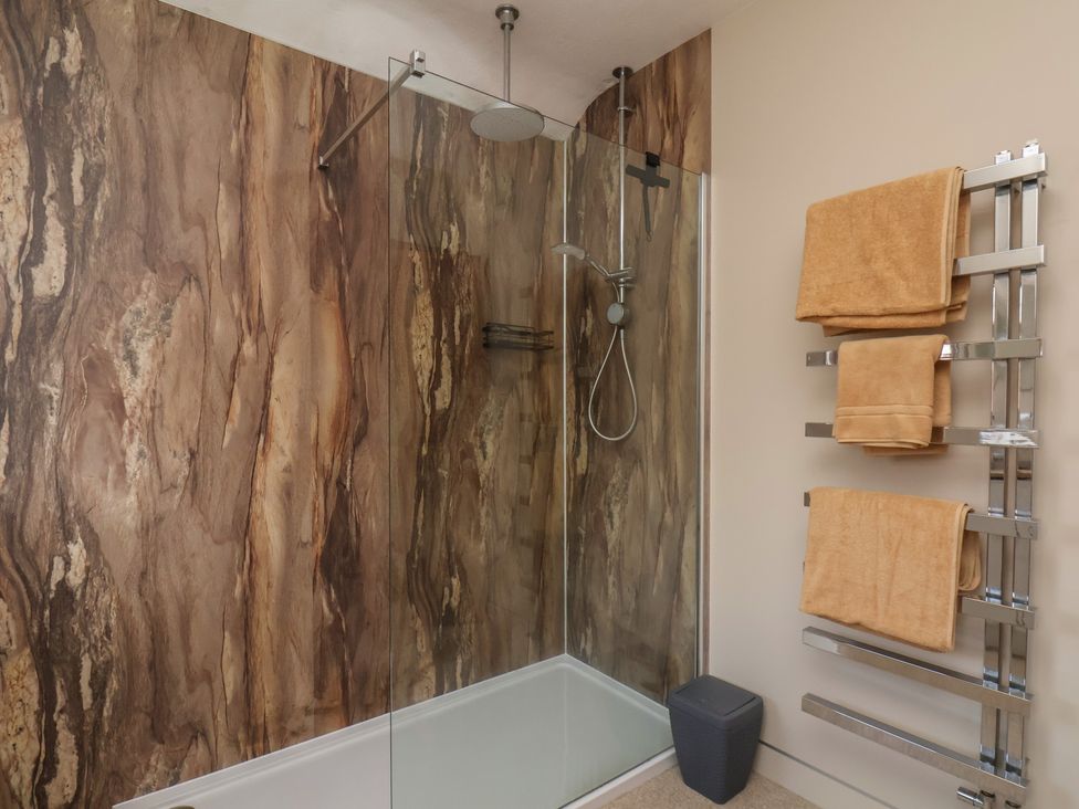 A bathroom with a shower and towel rack at 44 Love Lane in Whitby