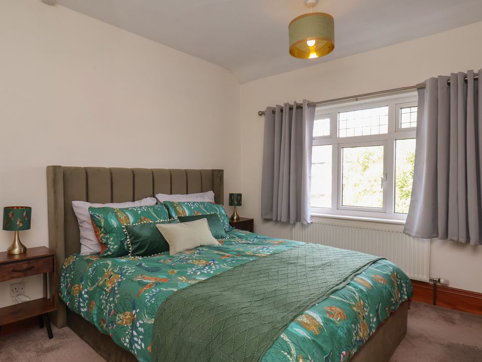 A bedroom with a bed and bedside tables at 44 Love Lane in Whitby