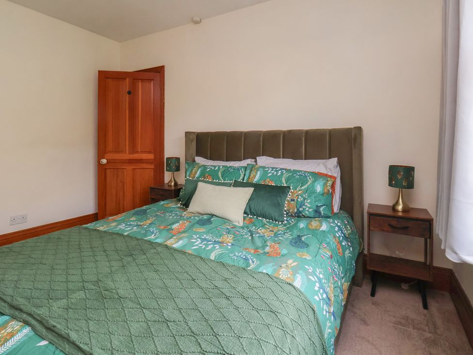 A bedroom with a bed and bedside table at 44 Love Lane Whitby
