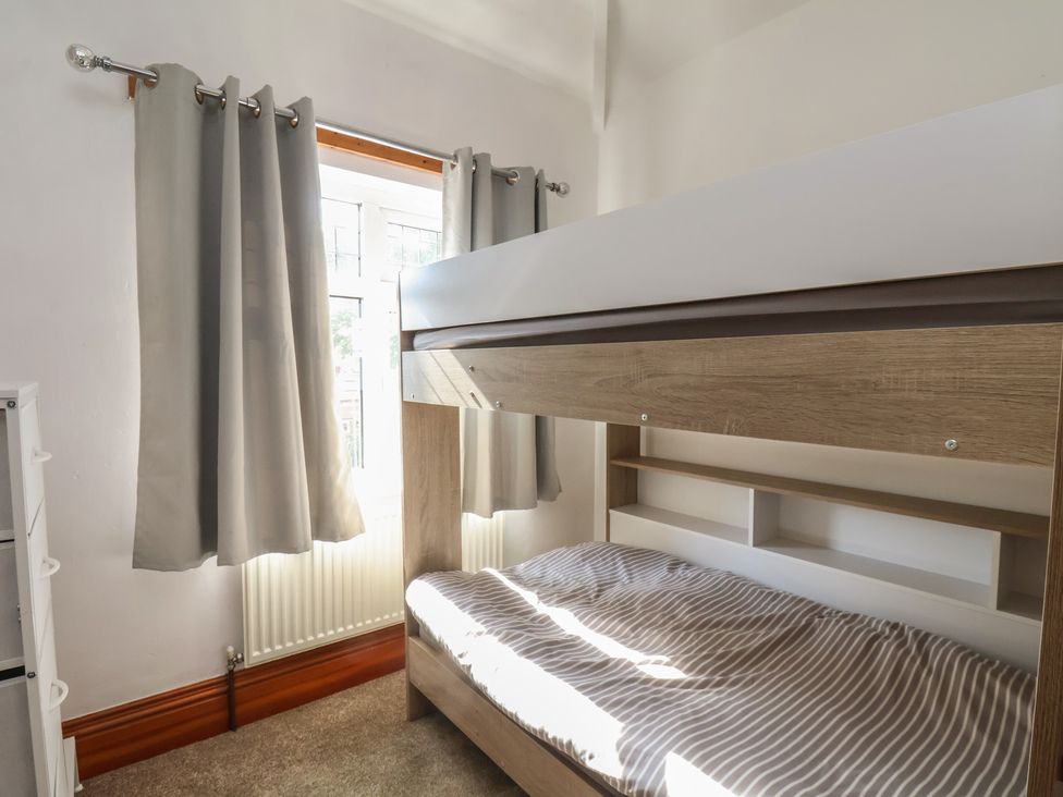 A bedroom featuring a bunk bed and curtains at 44 Love Lane Whitby