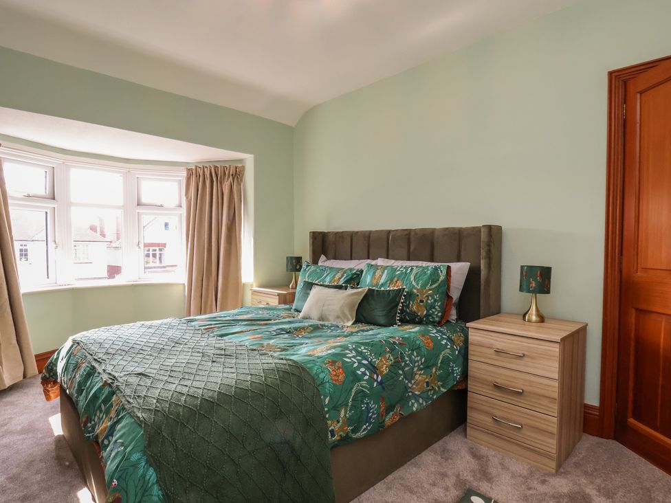 A bedroom with a bed and bedside table at 44 Love Lane in Whitby