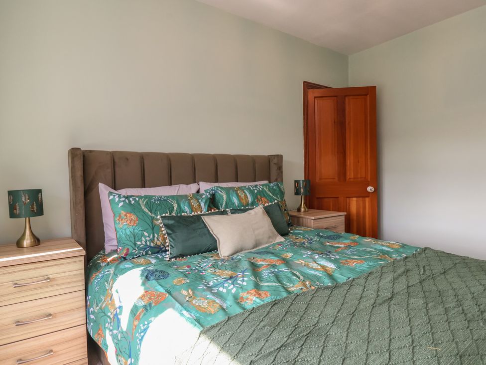 A bedroom with a bed and nightstand at 44 Love Lane in Whitby