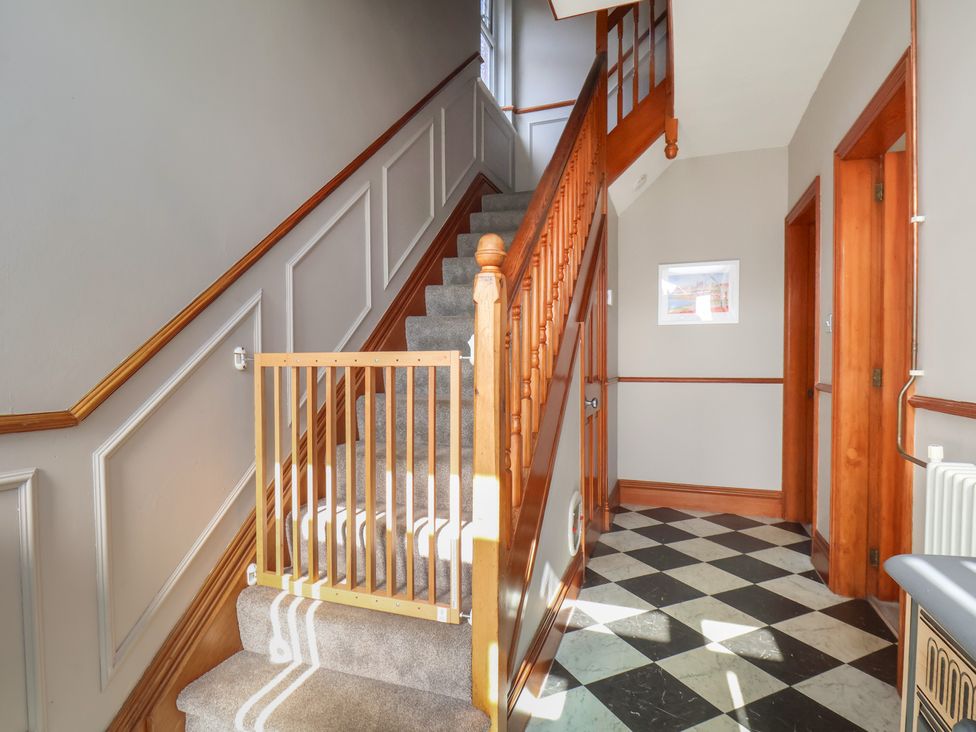A staircase with a baby gate in a hallway at 44 Love Lane, Whitby