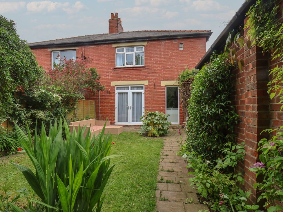 A garden with a house in the background at 44 Love Lane in Whitby
