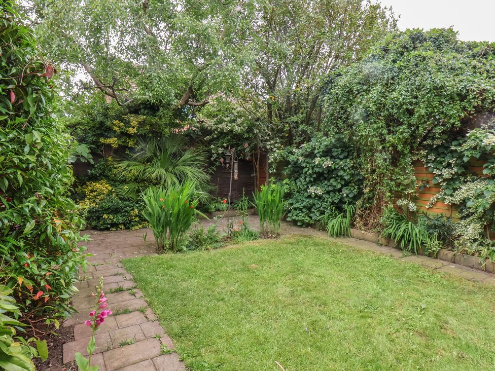 A garden with plants and grass at 44 Love Lane in Whitby