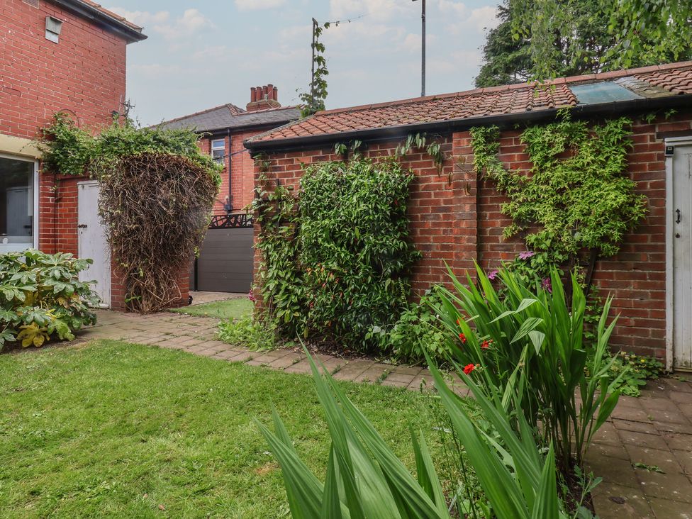 A garden with brick walls and plants at 44 Love Lane in Whitby