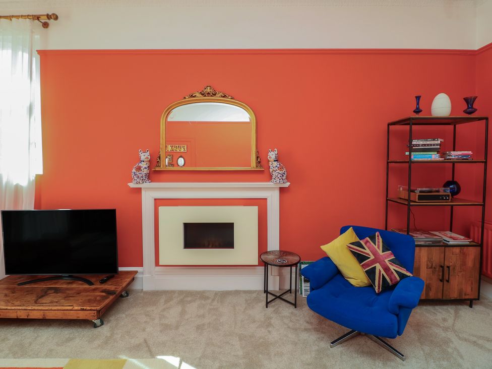 A living room with a television and fireplace at Tower Cottage in Nottingham