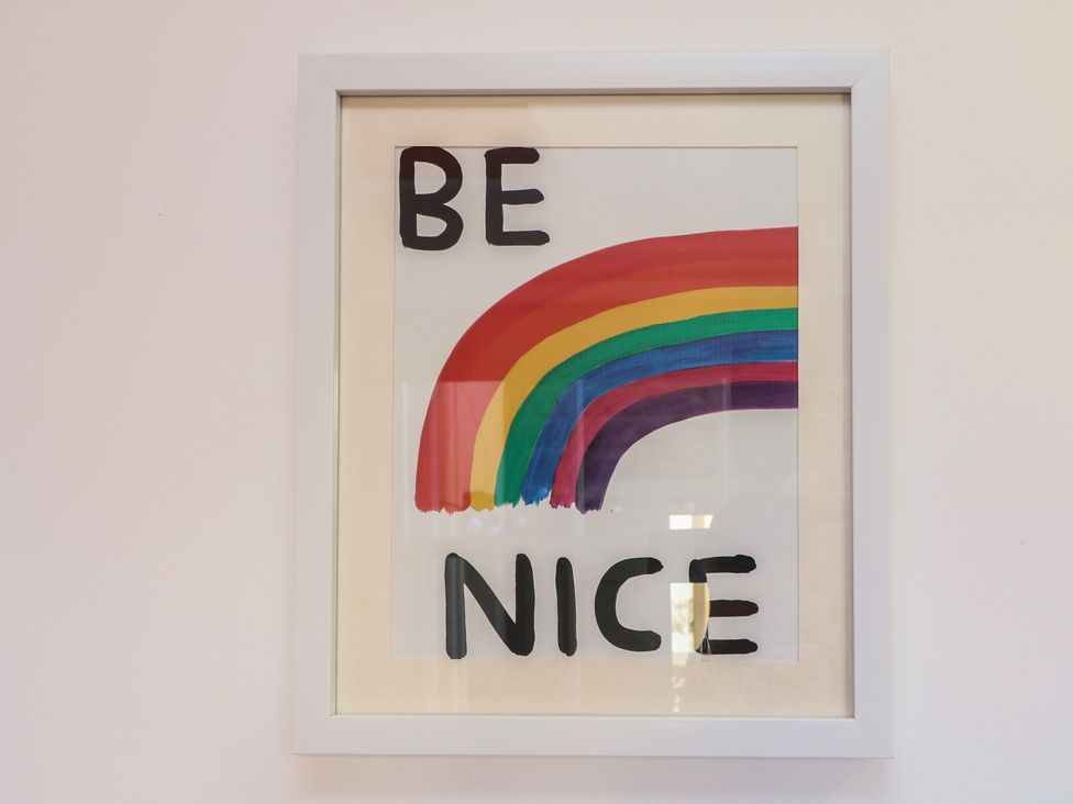 An art print with a rainbow and text at Tower Cottage Nottingham