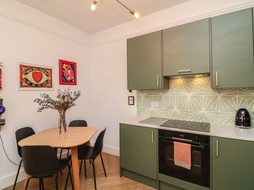 A kitchen with a table and chairs at Tower Cottage in Nottingham