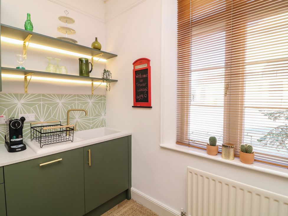 A kitchen with a sink and coffee machine at Tower Cottage Nottingham