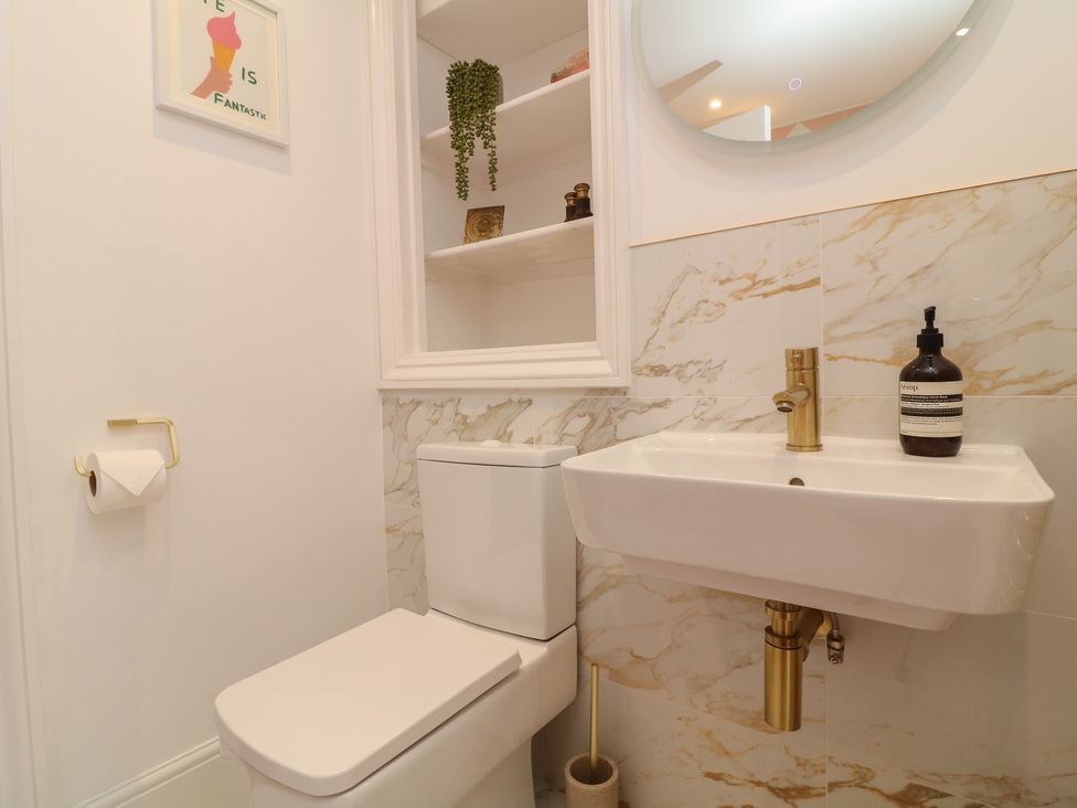A bathroom with a toilet and sink at Tower Cottage in Nottingham