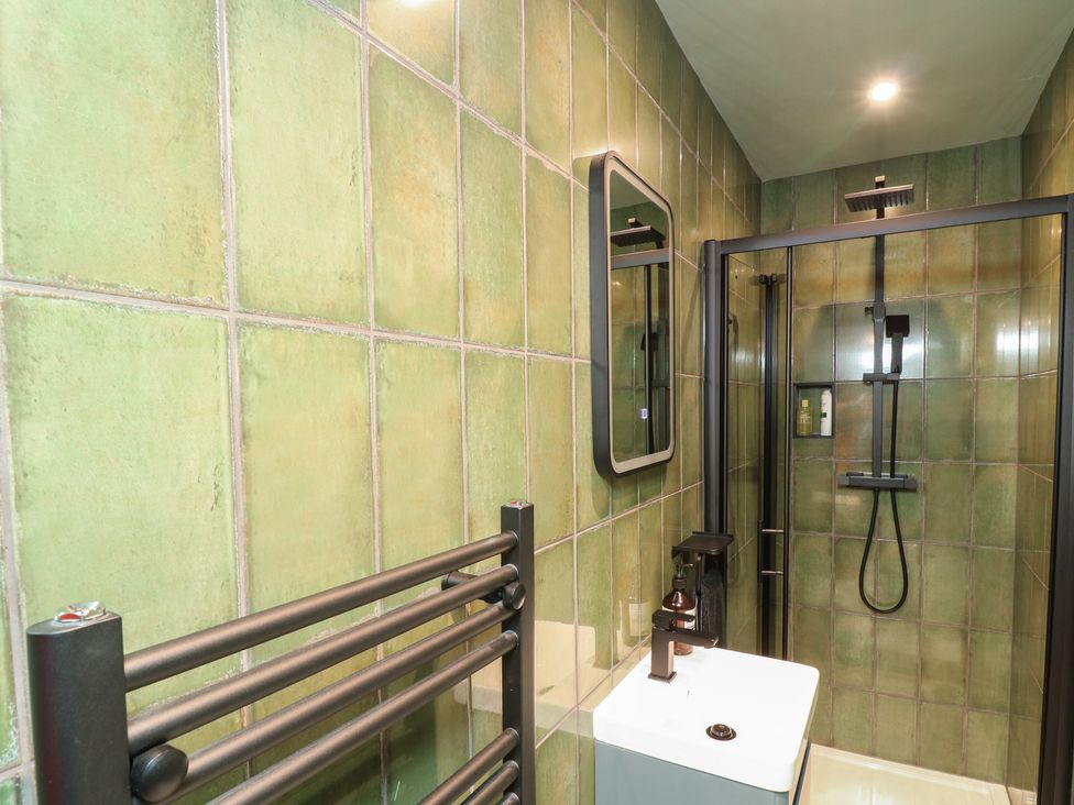 A bathroom with a shower and sink at Tower Cottage Nottingham