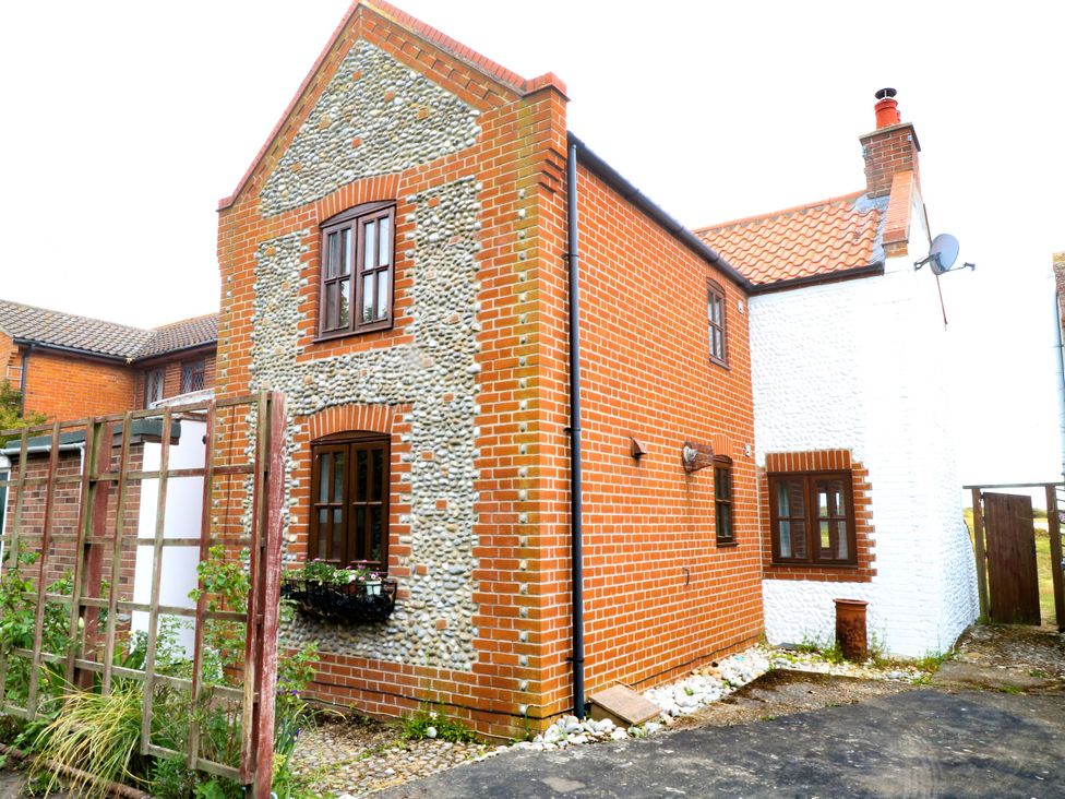 A house with a brick exterior and windows at Mabby in Great Yarmouth