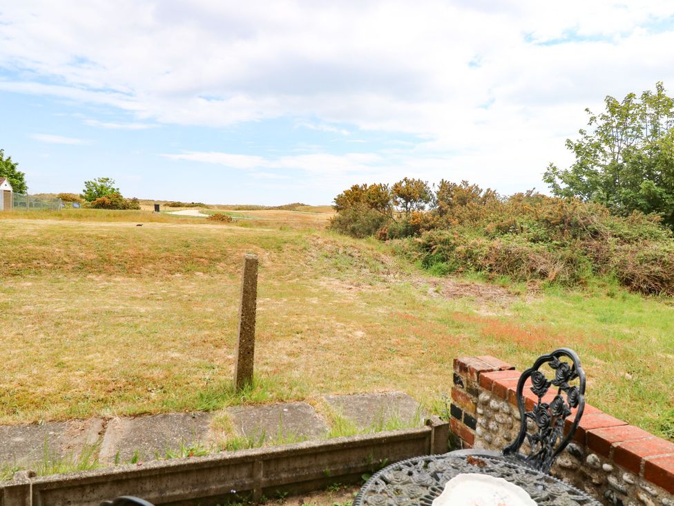A garden view with grass and bushes at Mabby, Great Yarmouth