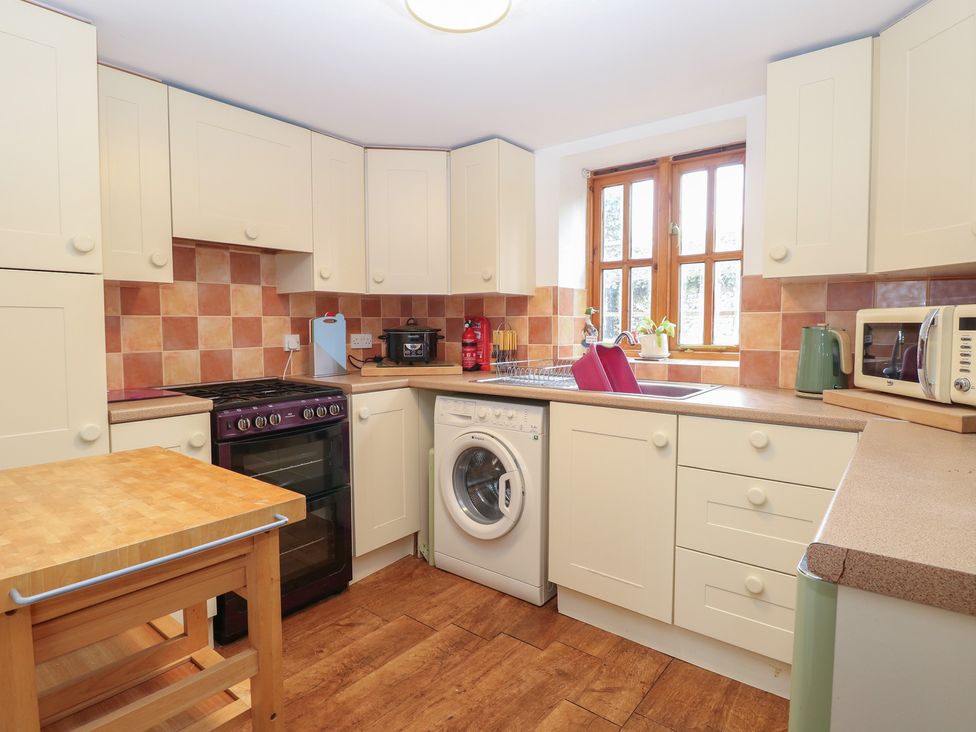 A kitchen with a washing machine and oven at Mabby in Caister-On-Sea