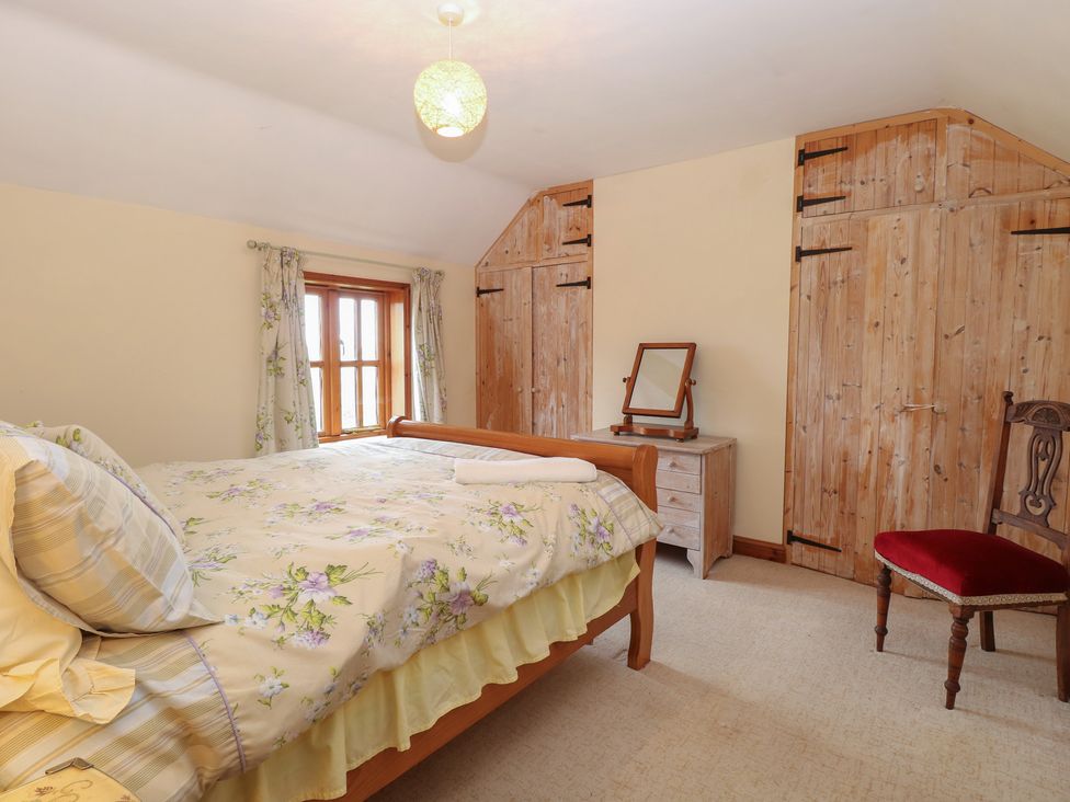 A bedroom with a bed and dresser at Mabby in Caister-On-Sea