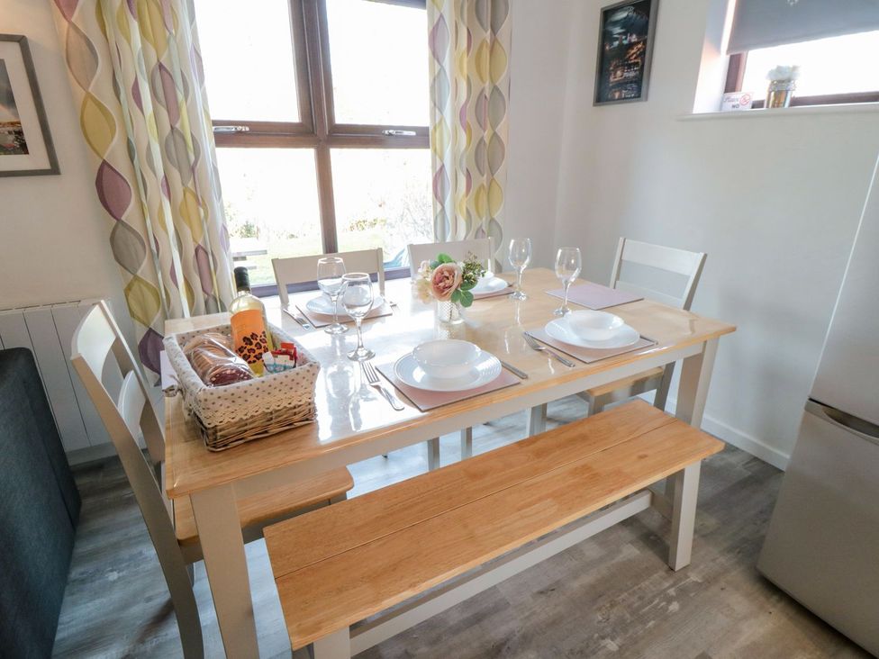 A dining room with a table set for a meal at Cha Cha's Cottage in Whitby