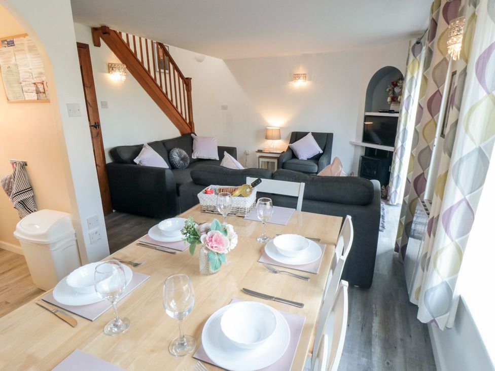 A dining area with a table and chairs at Cha Cha's Cottage in Whitby