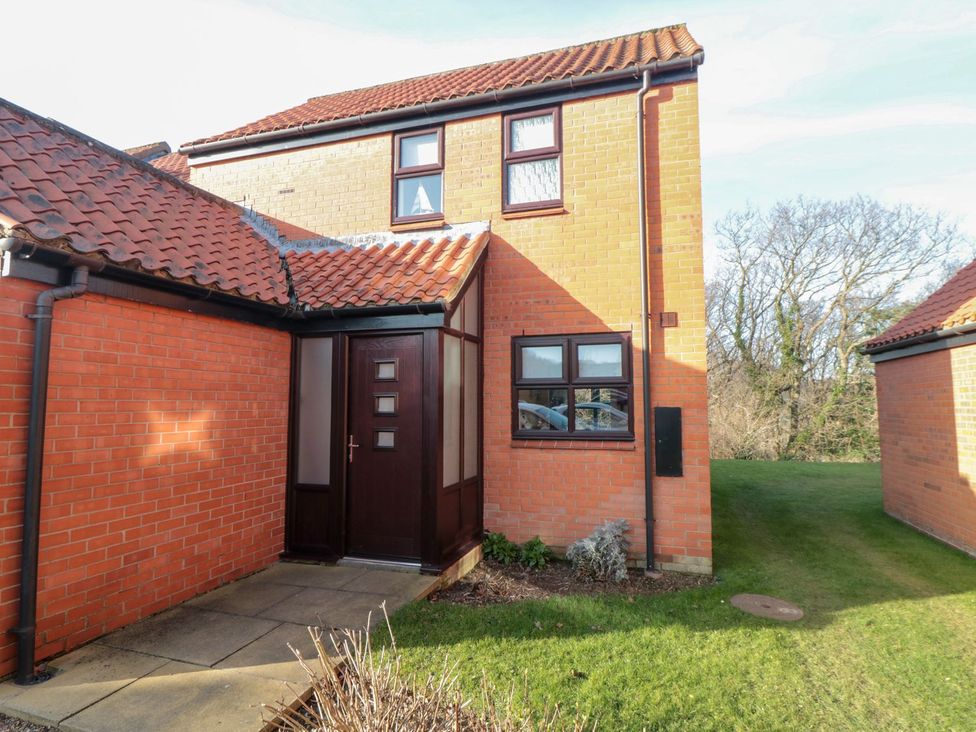 An exterior view of a house entrance at Cha Cha's Cottage in Whitby