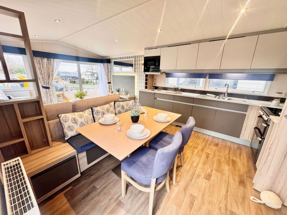 A kitchen with table and chairs at Chappies Caravan 2.0 Rhyl