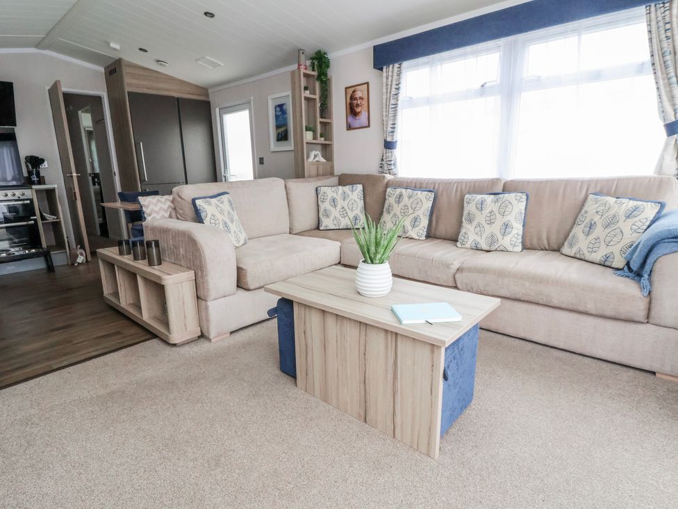 A living room with a sofa and coffee table at Chappie's Caravan 2.0 in Rhyl