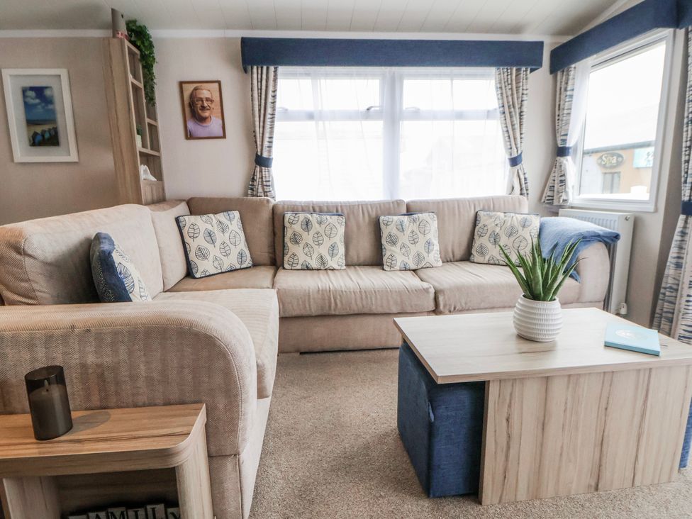 A living room with a sofa and coffee table at Chappie's Caravan 2.0 in Rhyl