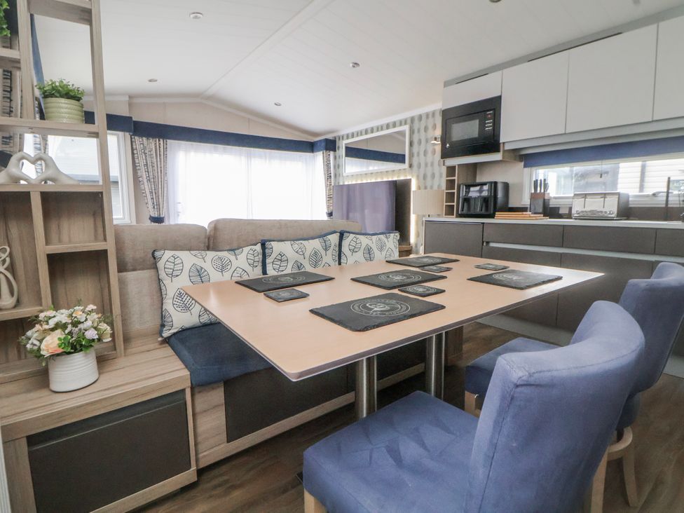 A dining room with a table and chairs at Chappie's Caravan 2.0 Rhyl