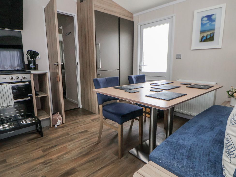 A dining room with a table and chairs at Chappie's Caravan 2.0 Rhyl