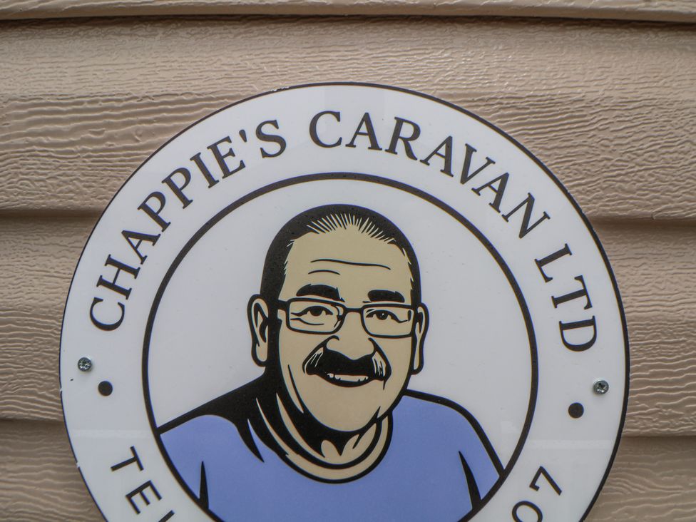 A sign for Chappie's Caravan Ltd featuring a graphic of a man at Chappie's Caravan 2.0 in Rhyl