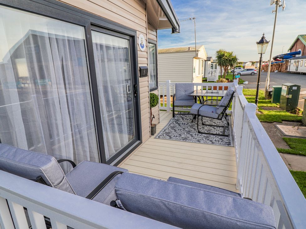 An outdoor seating area with table and chairs at Chappie's Caravan 2.0 Rhyl