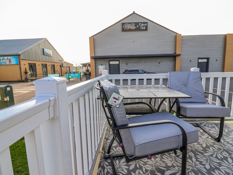 An outdoor seating area with chairs and a table at Chappie's Caravan 2.0 Rhyl