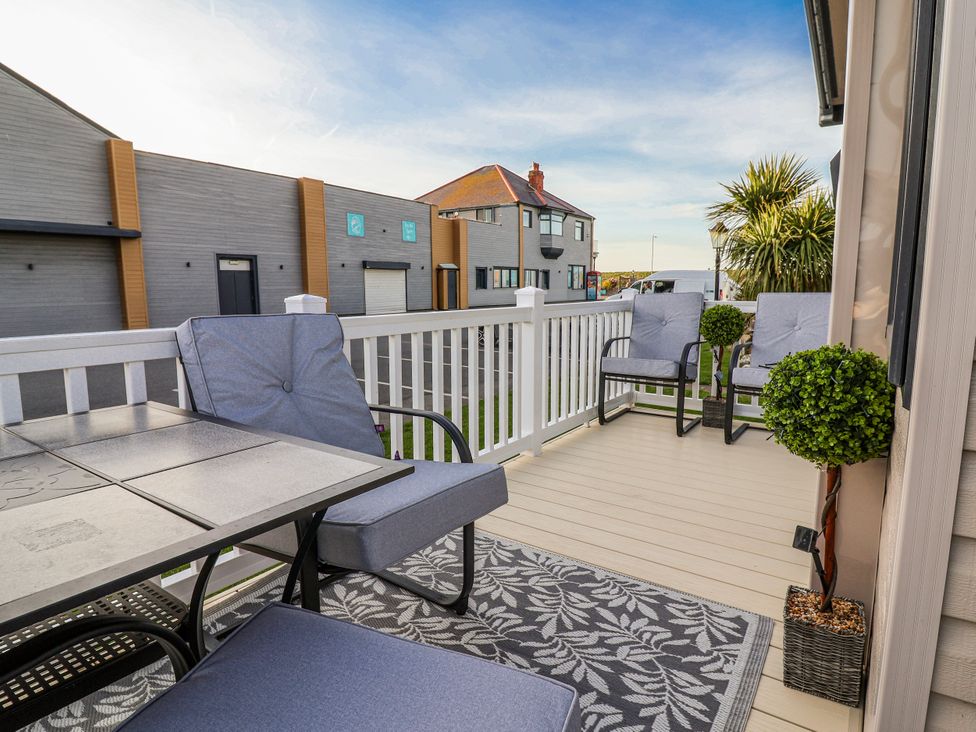 A patio with table and chairs at Chappie's Caravan 2.0 in Rhyl