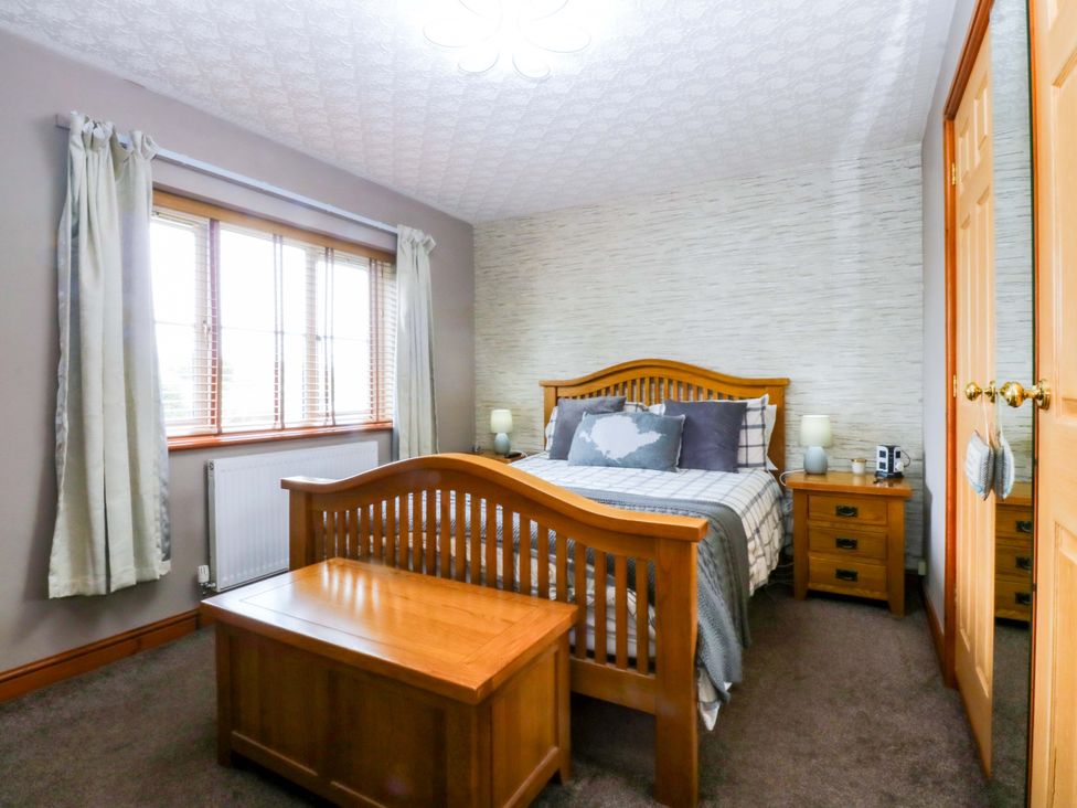 A bedroom with a bed and furniture at 36 Cae Rhos Holyhead