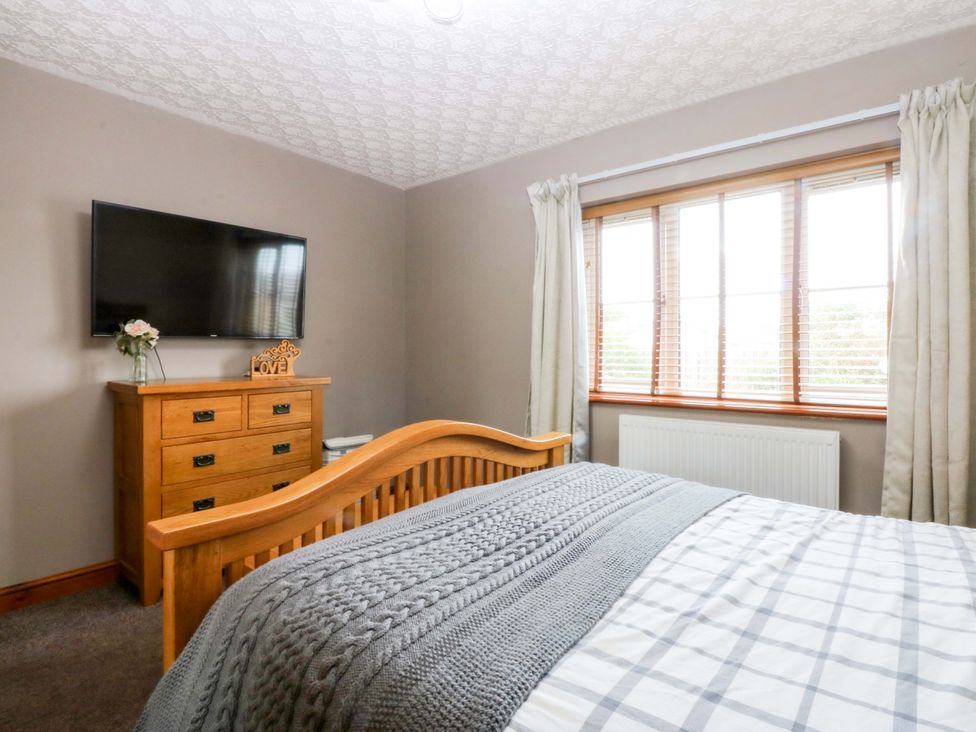 A bedroom with a bed and television at 36 Cae Rhos Holyhead