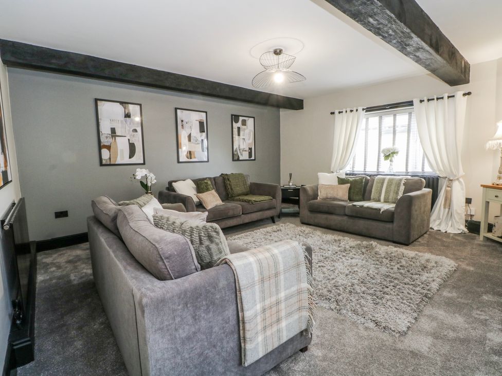 A living room with sofas and artwork on the wall at 2 Manor House farm, Higher Ogden near Newhey