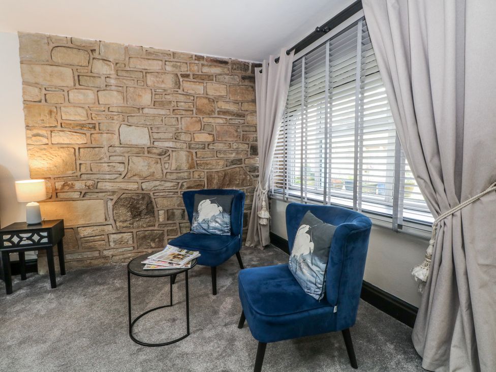 A sitting room with two blue armchairs and a side table at 2 Manor House farm Higher Ogden near Newhey