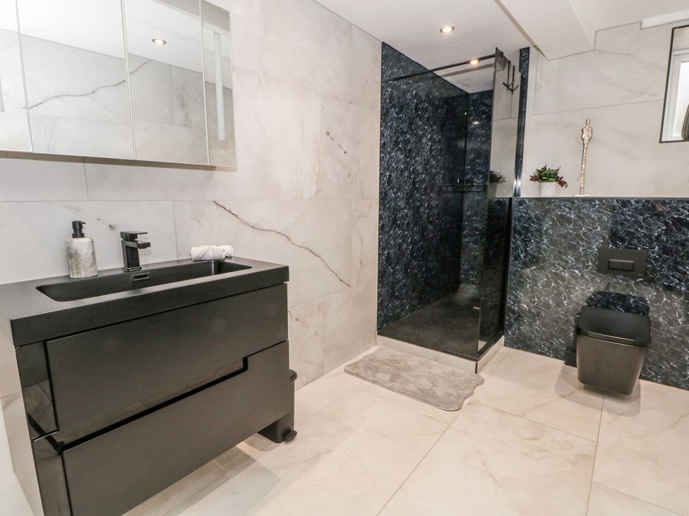 A bathroom with a sink, shower, and toilet at 2 Manor House farm, Higher Ogden near Newhey